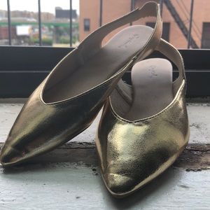 Gold pointed toe flats with open back